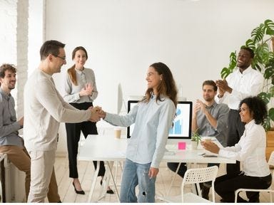 Nach der Elternzeit zurück in den Job. Freudiges Willkommen bei der Rückkehr im alten Job von den Kolleginnen und Kollegen.