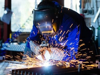 Schweißer arbeitet an einem Werkstück in seiner Umschulung Metallbauer