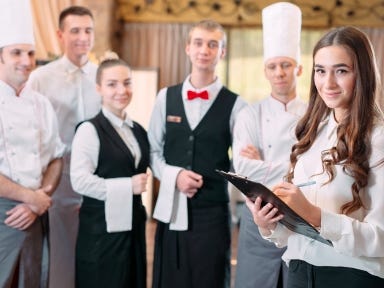 Ein Service Team steht geinsam einem Restaurant.