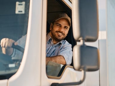 Berufskraftfahrer sitzt im LKW und blickt aus dem Fenster w&auml;hrend der Arbeit
